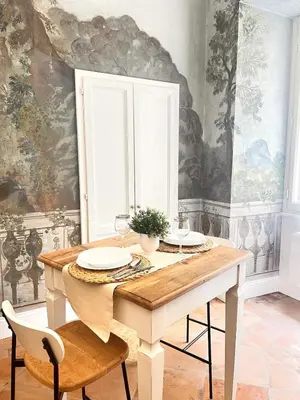 a dining room with a wooden table and chairs at Historic Fresco Suite Rome Colosseum Boutique Stay in Rome