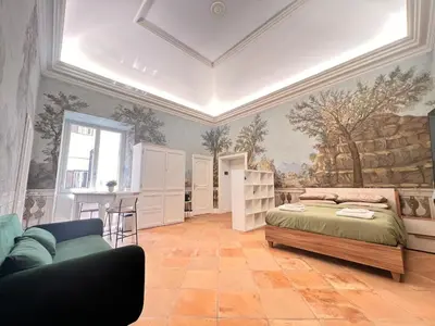 a bedroom with a bed and a couch at Historic Fresco Suite Rome Colosseum Boutique Stay in Rome