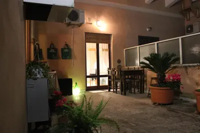 a living room with plants and a dining room at casa vacanze Borgo San Lazzaro in Rome