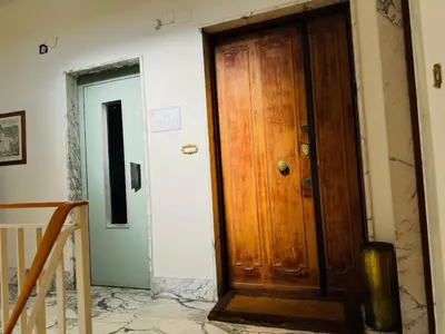 a wooden door in a room with a staircase at San Pietro in Vaticano Terrazza Giovy in Rome