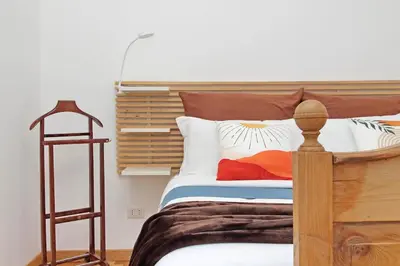 a bedroom with a wooden bed with white pillows at San Pietro in Vaticano Terrazza Giovy in Rome