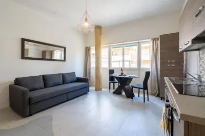 a living room with a couch and a table at NEW OPENING! Close to St Peter & Free Netflix in Rome