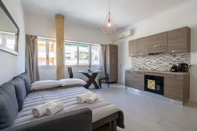 a living room with a couch and a fireplace at NEW OPENING! Close to St Peter & Free Netflix in Rome
