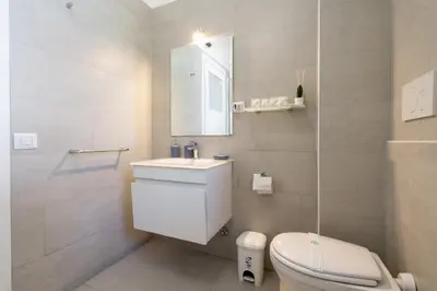 a bathroom with a toilet and a sink and a mirror at NEW OPENING! Close to St Peter & Free Netflix in Rome