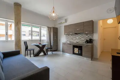 a living room with a couch and a fireplace at NEW OPENING! Close to St Peter & Free Netflix in Rome