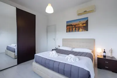 a bedroom with two beds with towels on them at NEW OPENING! Close to St Peter & Free Netflix in Rome