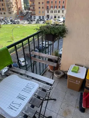 a balcony with a bench and a view of a city at Sunny apartment in central Rome in Rome
