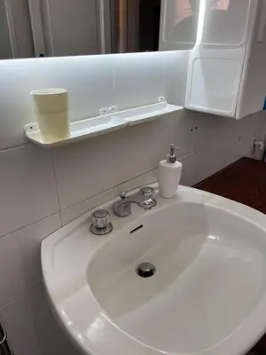 a white sink in a bathroom with a mirror at Sunny apartment in central Rome in Rome