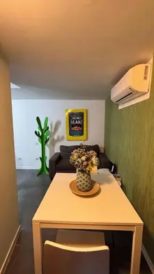 a living room with a table with a vase of flowers at la casa di lola in Rome