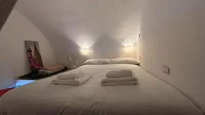 a bedroom with a white bed with towels on it at la casa di lola in Rome