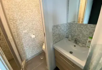 a bathroom with a sink and a shower and a toilet at la casa di lola in Rome