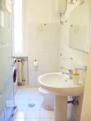 a white bathroom with a sink and a toilet at Blue House Termini-Colosseo in Rome