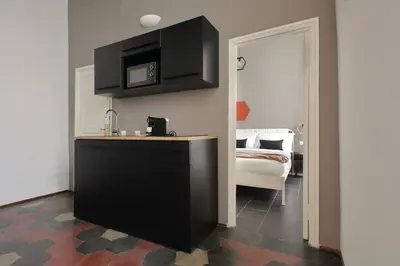 a kitchen with a sink and a microwave at Pantheon Authentic and Modern Apartment in Rome