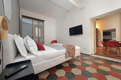 a hotel room with a large bed and a television at Pantheon Authentic and Modern Apartment in Rome