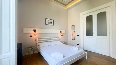 a bedroom with a white bed in a room at Casa Daria in Rome