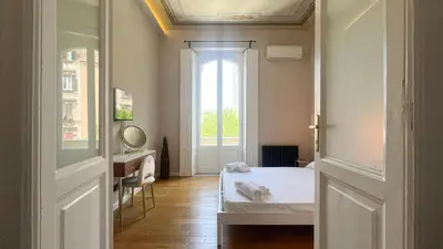 a bedroom with a white bed and a window at Casa Daria in Rome