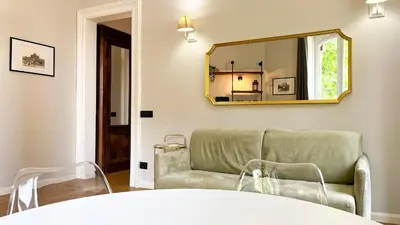 a living room with a couch and a mirror at Casa Daria in Rome