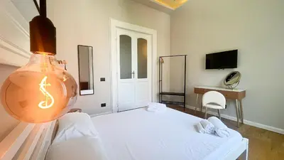 a bedroom with a white bed and a lamp at Casa Daria in Rome