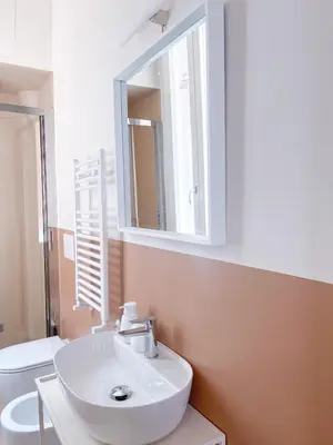 a bathroom with a white sink and a mirror at Vatican Apartment Borgo Pio 160 by MSuite in Rome