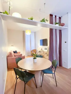 a living room with a table and chairs at Vatican Apartment Borgo Pio 160 by MSuite in Rome