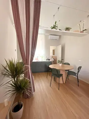 a room with a table and chairs and a dining room at Vatican Apartment Borgo Pio 160 by MSuite in Rome