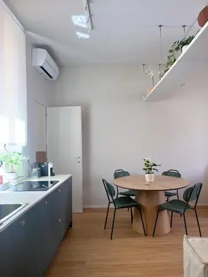 a kitchen and dining room with a table and chairs at Vatican Apartment Borgo Pio 160 by MSuite in Rome