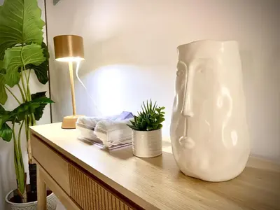a white vase sitting on top of a table at Appartamento metro Ponte Lungo in Rome