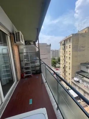 a balcony of a building with a ladder on it at Bright and Cozy Studio Apartment near Trastevere Station in Rome