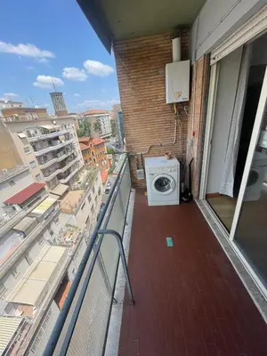 a washing machine on the balcony of a building at Bright and Cozy Studio Apartment near Trastevere Station in Rome