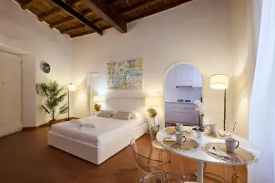 a bedroom with a bed and a table with chairs at Navona Maison in Rome