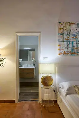 a bedroom with a bed and a bathroom with a mirror at Navona Maison in Rome