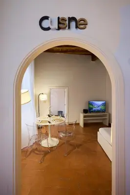 a living room with a table and chairs and a couch at Navona Maison in Rome