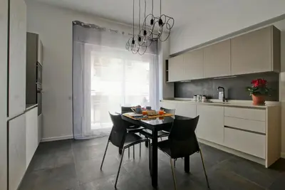 a kitchen with a table and chairs in a kitchen at Modern house near Trastevere in Rome