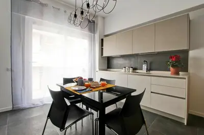 a kitchen with a table and chairs in a room at Modern house near Trastevere in Rome
