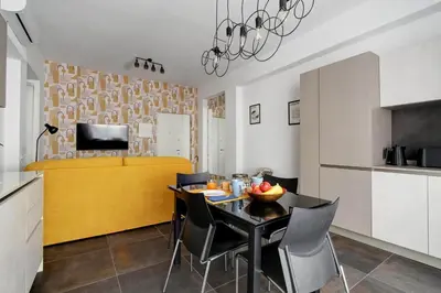 a kitchen and dining room with a black table and chairs at Modern house near Trastevere in Rome