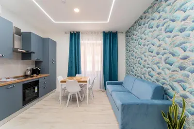 a bedroom with a bed with blue walls and blue curtains at Stylish Vatican Stay - WiFi Metro Walk Everywhere in Rome