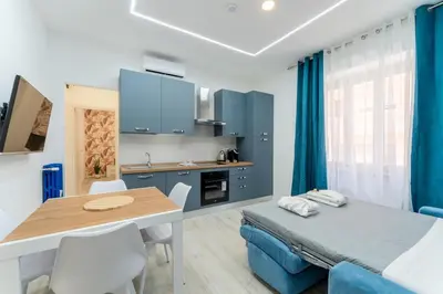 a kitchen and dining room with a table and chairs at Stylish Vatican Stay - WiFi Metro Walk Everywhere in Rome