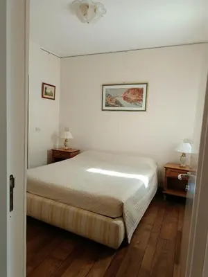 a bedroom with a bed and two night stands at Via del Corso Apartment in Rome