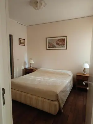 a bedroom with a bed with two night stands and two lamps at Via del Corso Apartment in Rome