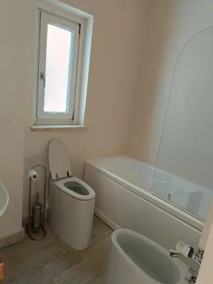 a bathroom with a toilet and a tub and a sink at Via del Corso Apartment in Rome