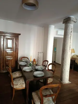 a dining room with a wooden table and chairs at Via del Corso Apartment in Rome