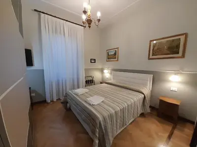 a bedroom with a large bed in a room at Il Sole di Roma in Rome