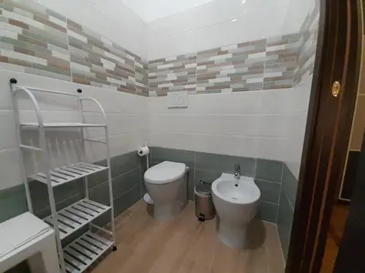 a bathroom with a toilet and a sink at Il Sole di Roma in Rome