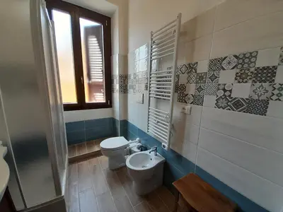 a bathroom with a toilet and a sink at Il Sole di Roma in Rome