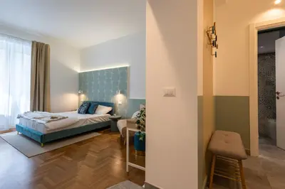 a small bedroom with a bed and a bathroom at Cornelia Vatican Suites in Rome
