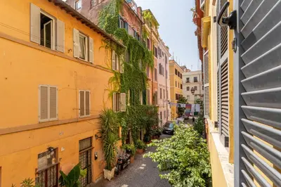 an alley between two buildings with a car parked at Domus Leopardo, Typical Trastevere Flat in Center in Rome