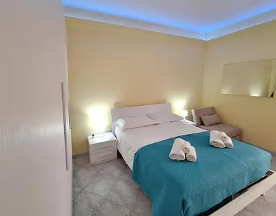 a bedroom with a bed with two white shoes on it at MARIA TERESA Apartment II - Refined Living with Excellent City Links - Via Alessandria - QUARTIERE TRIESTE in Rome