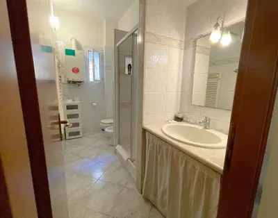 a bathroom with a sink and a toilet at MARIA TERESA Apartment II - Refined Living with Excellent City Links - Via Alessandria - QUARTIERE TRIESTE in Rome