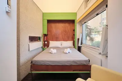a bedroom with a bed with two towels on it at NEW 3BDR Lab4House a Villa Borghese Roma Parioli in Rome