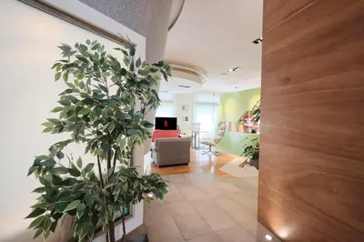 a living room with a couch and a plant at NEW 3BDR Lab4House a Villa Borghese Roma Parioli in Rome